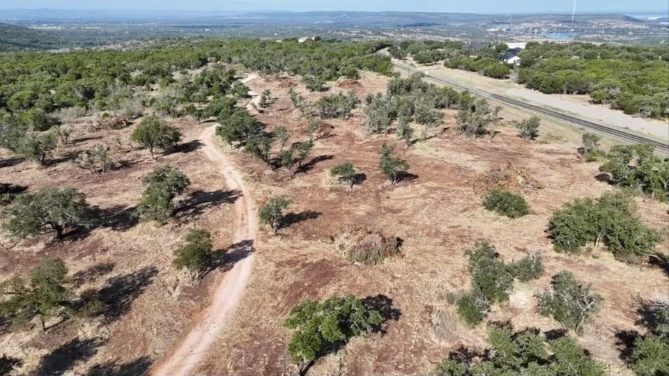 Drone view of a property after clearing, with oaks left standing