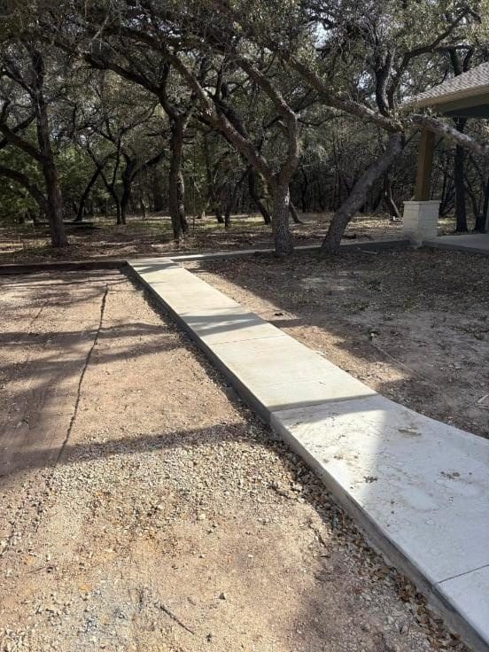 New concrete walkway under oak trees